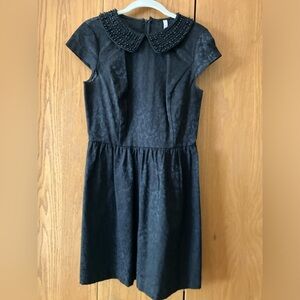 Women’s black cocktail dress. Jeweled collar.